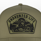 Closeup of Green hat with UNDAUNTED LIFE patch